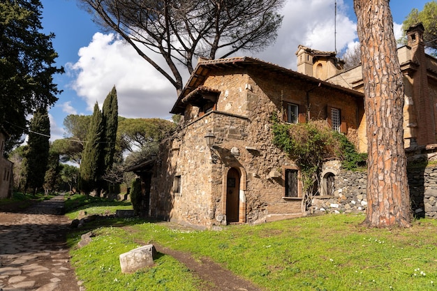 A stone house with a large tree in front of it