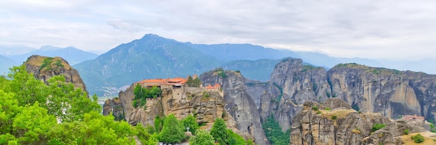 Stone monastery in the mountains Kalabaka Greece summer cloudy day in Meteora mountain valley