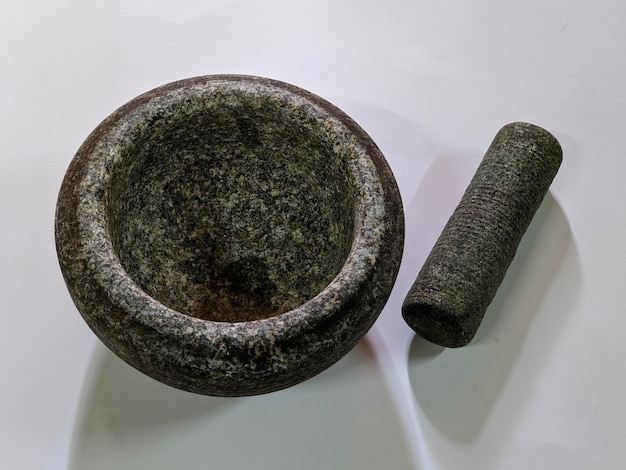 A stone mortar and pestle on isolated background