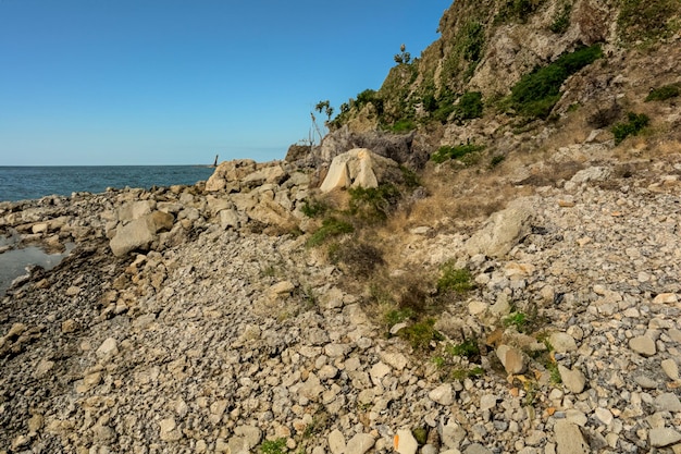 Stone path at the foot of a mountain on the way to the sea