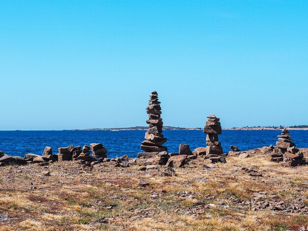 Stone pebble tower next to the sea shore