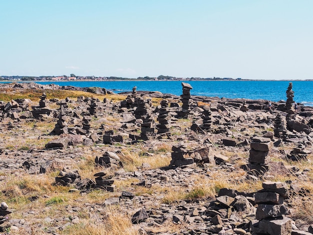 Stone pebble tower next to the sea shore