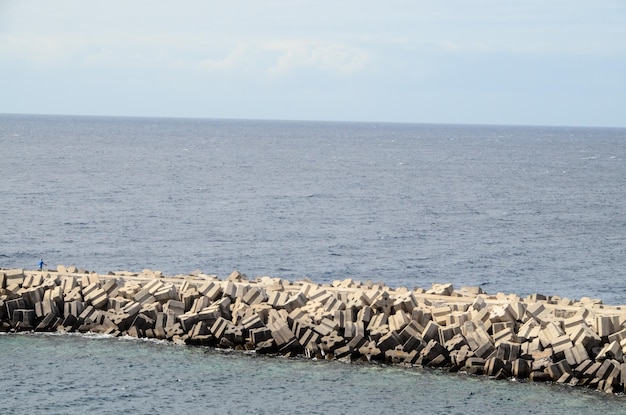 Stone Pier on the blue Atlantic Ocean Water