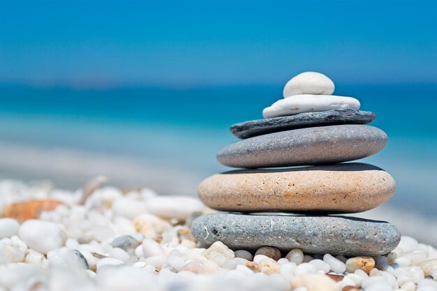 Stone pile on white pebbles by the shore