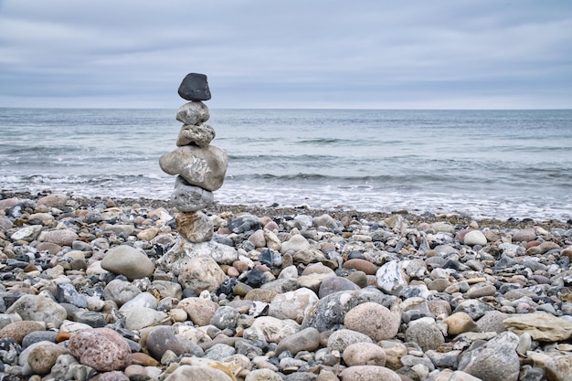 Stone pyramid on the beach overlooking the sea Danish coast Scandinavia landscape