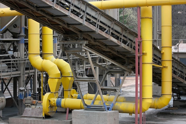 Stone quarry with silos conveyor belts and piles of stones