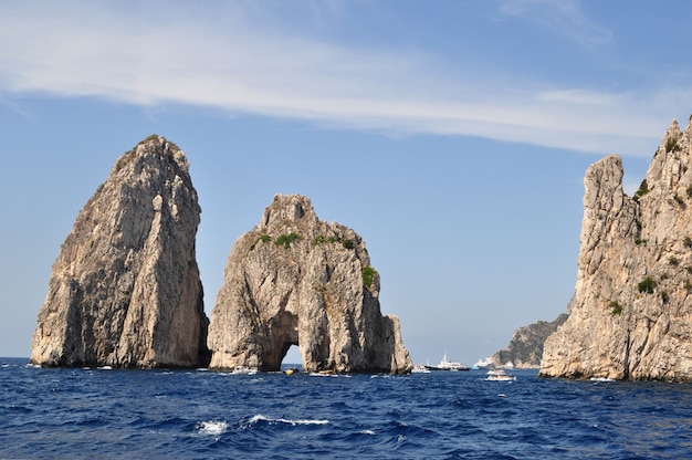 stone rock rises from the water in the sea