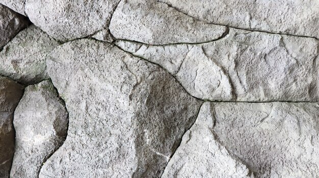 Stone rock texture or background. Gray rocky uneven surface, natural seamless backdrop for design. Copy space.