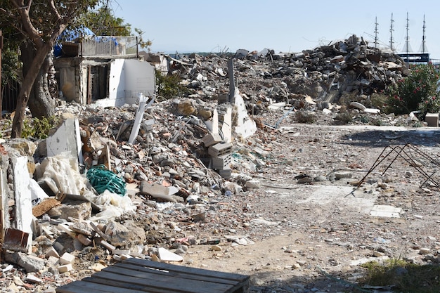 Stone ruins of a ruined house on the sea. the consequences of\
the earthquake and tsunami. rubbish building mountains