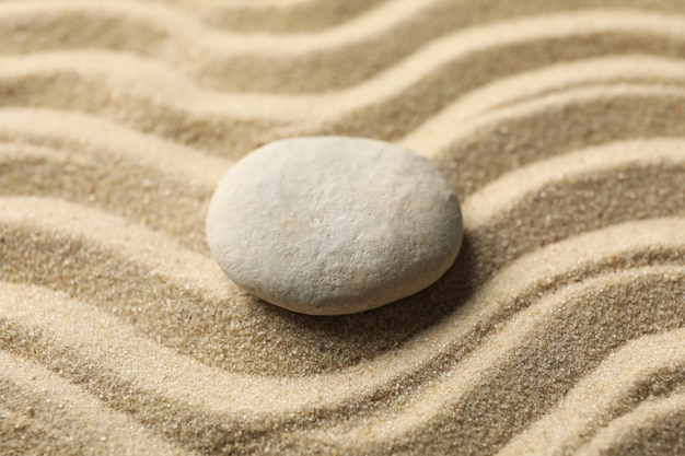 Stone on the sand with patterns. Zen concept