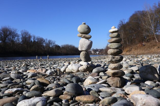 Stone stack on rock against sky