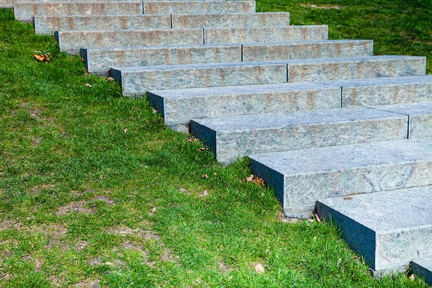 Stone staircase among the green lawn. Fragment.