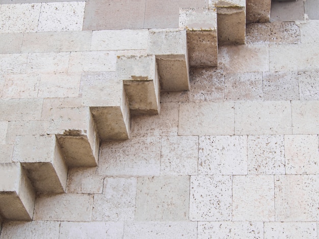 Stone stairs on the wall outside of the building.