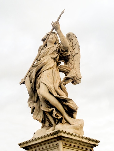 A stone statue of an angel on the bridge of angels