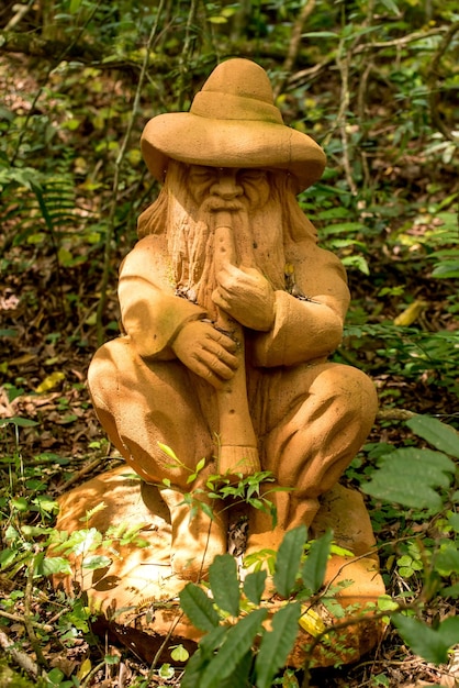 Stone statue of a gnome playing the flute