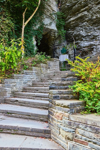 Stone steps winding up into cliff wall with tunnel