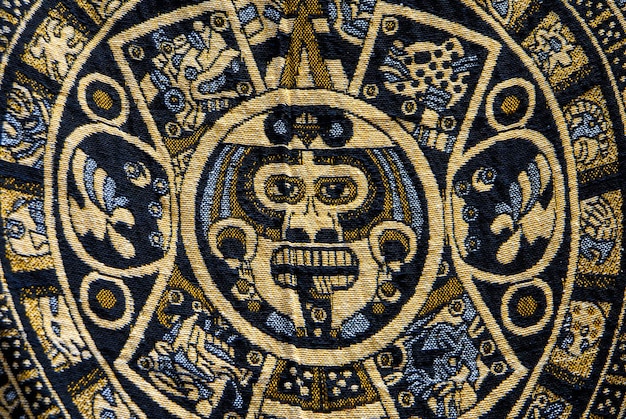 stone of the sun or Aztec calendar or solar calendar embodied in a Mexican textile or handicraft