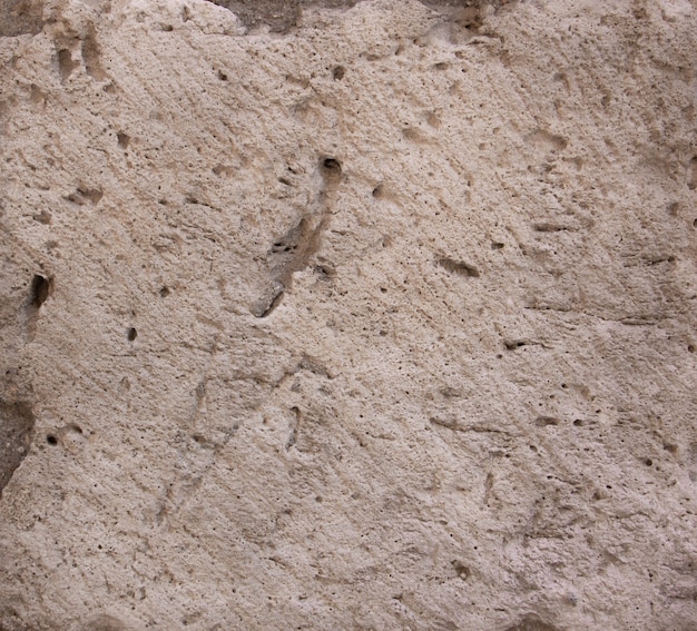 Stone texture in beige with holes. Background.