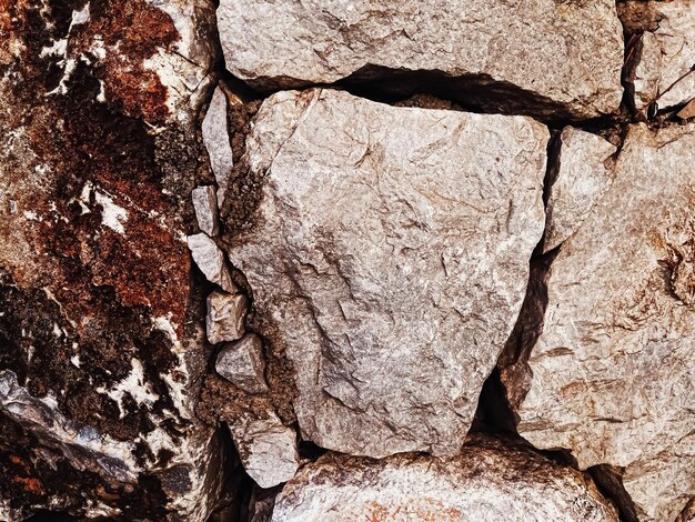 Stone texture and exterior design concept stonewall made of natural rocks as architectural surface b...