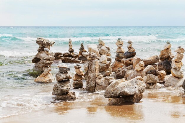 Фото Каменная башня на фоне голубого моря для медитации баланса и темы дзен