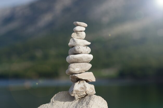 Photo stone tower on the beach and blur background