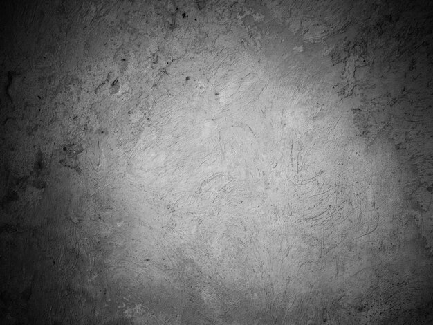 Stone wall in black and white stucco background old concrete texture of old cement facade