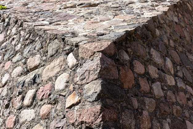 a stone wall in a triangular shape with a shadow on it