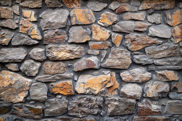 Stone wall Wall of hewn wild stone Stone background