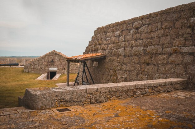 Foto un muro di pietra con una panca e un muro di mattoni con un cartello che dice 