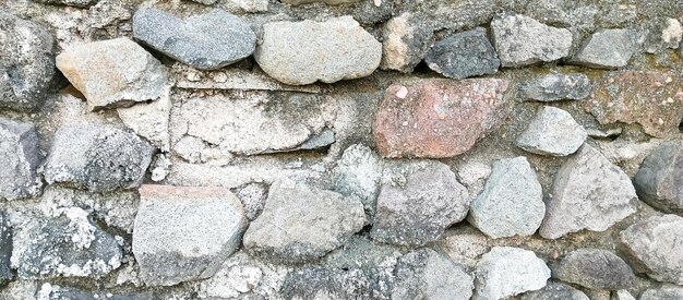 a stone wall with a small bird on it