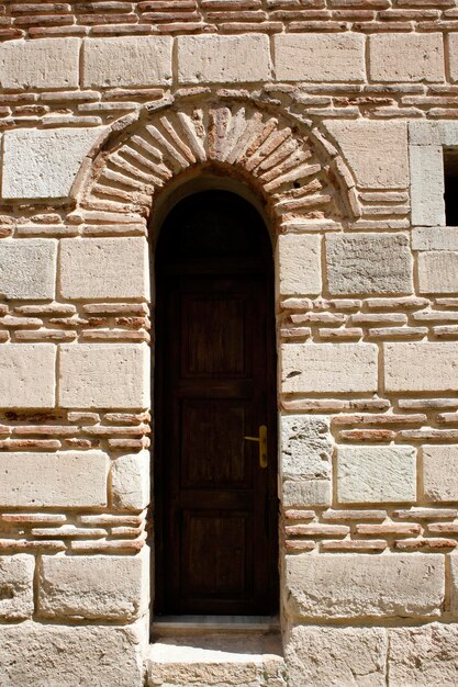 Stone walls and wooden door of an old building