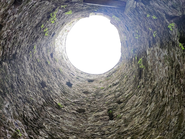 Photo stone well hole old construction from inside fall down in the well