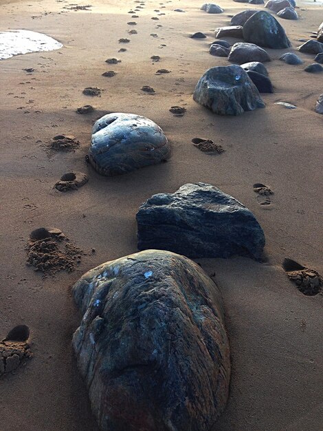 Stones and footprints on beach sand