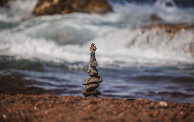 Stones pyramid on pebble beach symbolizing stability zen harmony balance