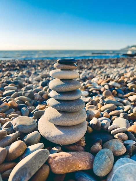 Stones pyramid on the seashore at sunset