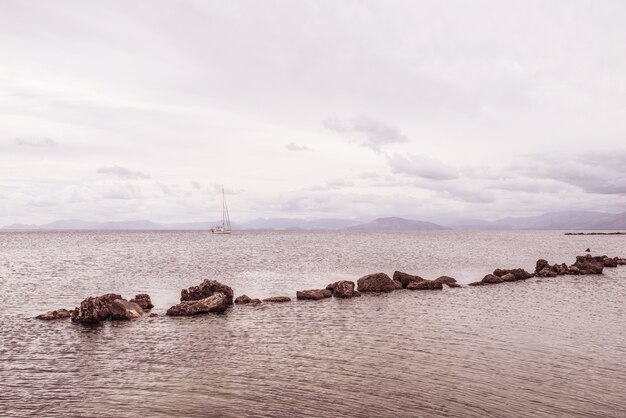 Stones in row in Ionian sea. Greece.