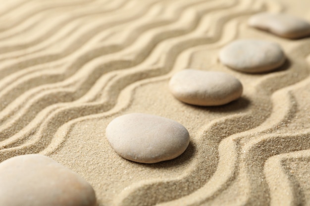 Stones on the sand with patterns