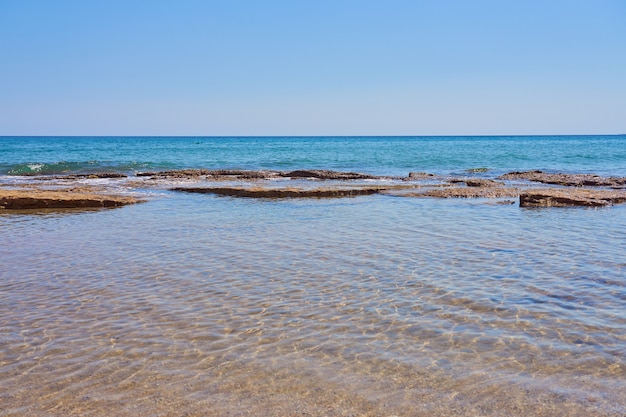 Stones on the shore of the warm tropical sea in Crete.