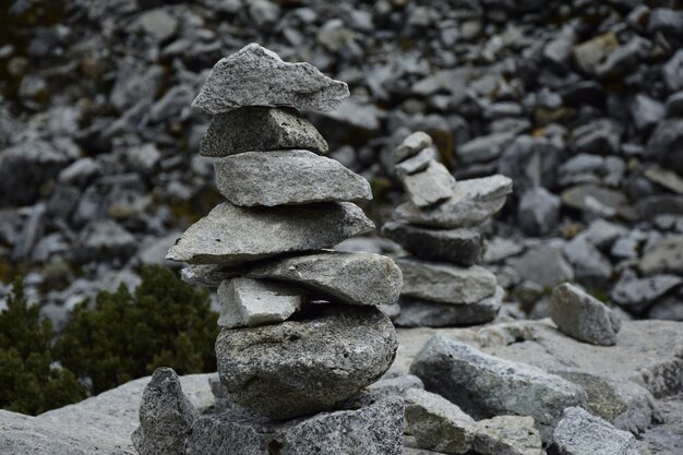 Stones stacked against a background of stones on the way to\
lagoon 69 huascaran national park in the sands of peru