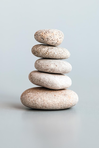 Stones stacked in pyramid balance stability zen meditation body mind and soul harmony concept