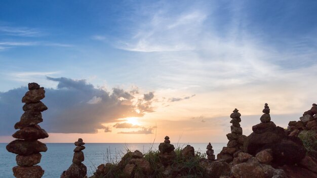 Photo stones stacked on rocks against sky during sunset