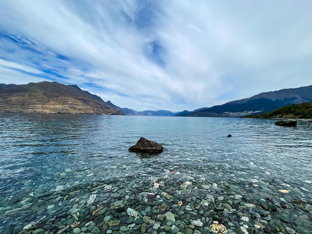 stones under the surface of the clean transparent water the lake at Queenstown