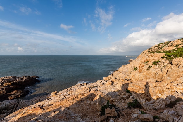 Stones of various shapes weathered by the sea under the blue sky