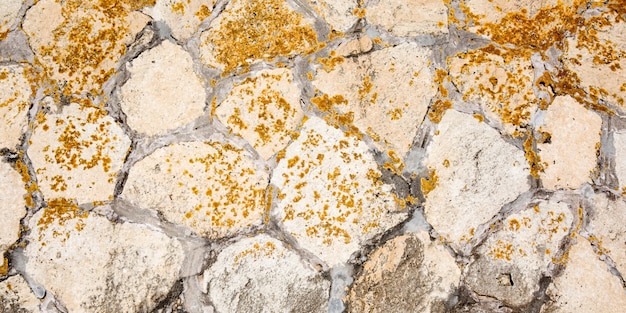 Stones wall background of stone old texture ancient brown