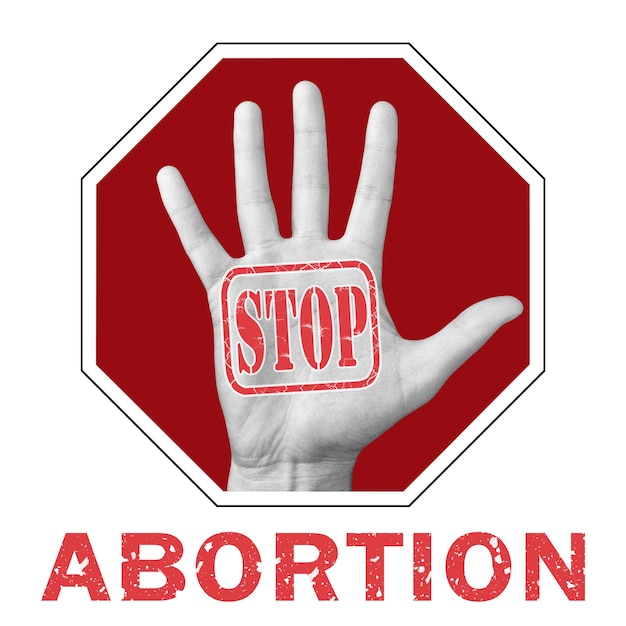 Photo stop abortion conceptual illustration. open hand with the text stop abortion. global social problem