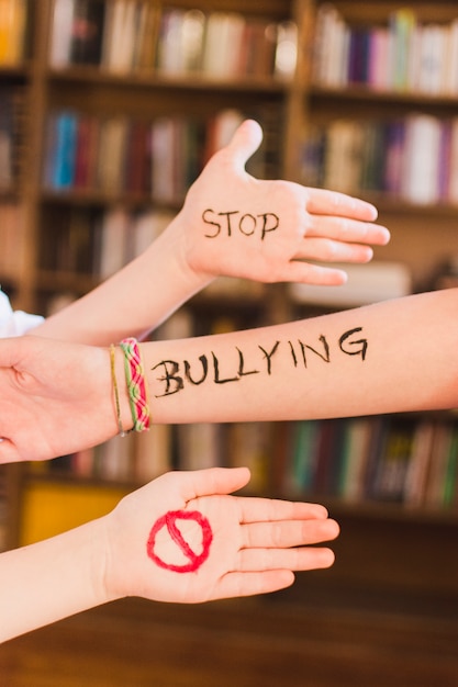 Photo stop bullying message on children's arms