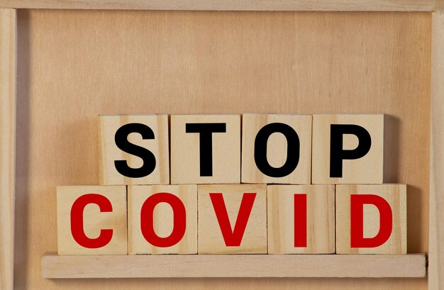 Stop coronavirus word written on wood block text on wooden table for your desing