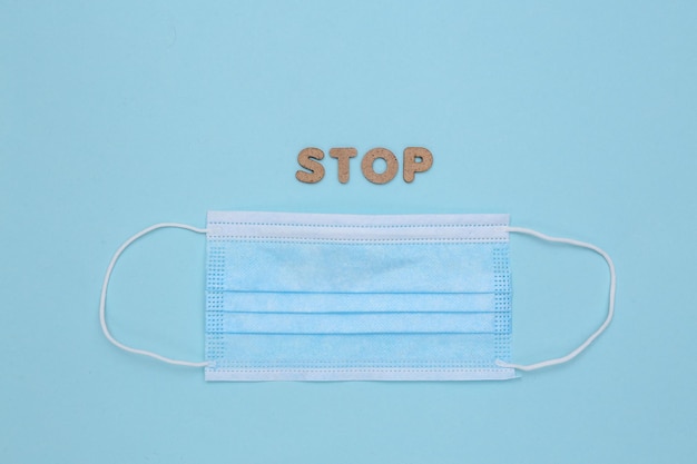 Stop covid-19. Medical face mask on blue background