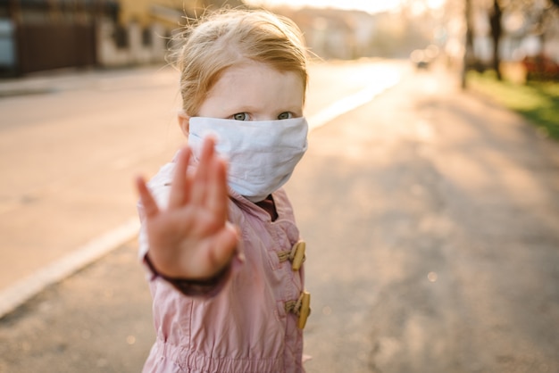 Stop de coronavirus- en virusepidemische ziekten. Gezond kind in medisch beschermend masker dat gebaareinde toont. Bescherming en preventie van de gezondheid tijdens griep en besmettelijke uitbraak.