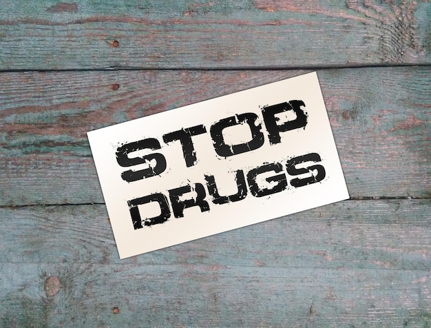 Stop drugs woorden op kaart op houten tafel Verslavingen gezondheidszorg concept